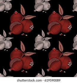 Embroidered fruits and leaves of pomegranate on a black background. Embroidery for fabrics, patches and garments. Seamless pattern. Vector