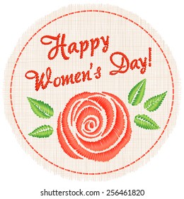 Embroidered (satin stitch) inscription "Happy women's day" and one rose on a round piece of cloth