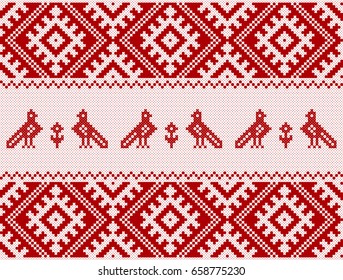 Embroidered white pattern on a red background with pigeons