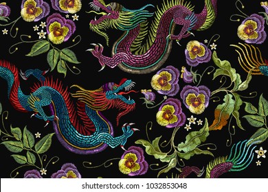 Embroidery asian dragons and beautiful flowers seamless pattern. Clothes, textile design template 