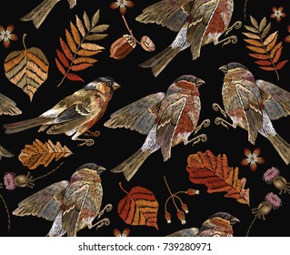 Embroidery autumn and birds seamless pattern. Fashionable template for design of clothes, t-shirt design. Classical september embroidery autumn leaves, bullfinch and titmouse. 