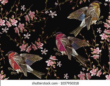 Embroidery birds and blossoming cherry seamless pattern. Classical embroidery bullfinch and titmouse on branch blossoming sakura. Spring fashion art, template for design of clothes, t-shirt design 