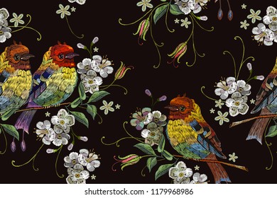 Embroidery birds and blossoming cherry seamless pattern. Template for clothes, textiles, t-shirt design