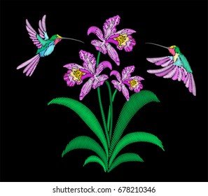 Embroidery birds and flower isolated on black. Violet iris in bloom and hummingbird.