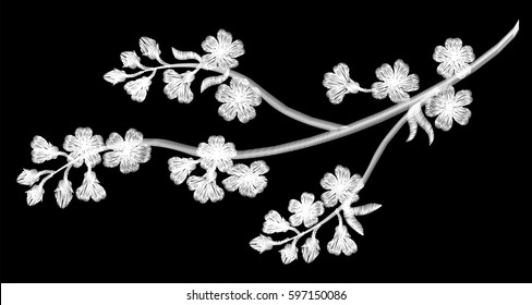 Embroidery blossoming cherry branches on a black background. white petals fall off. fashion clothing decoration. traditional pattern. vector illustration