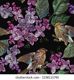 Embroidery blossoming lilac flowers and birds seamless pattern. Spring art. Fashion template for clothes, textiles 
