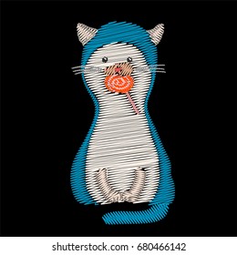 Embroidery cat with candy isolated on black.