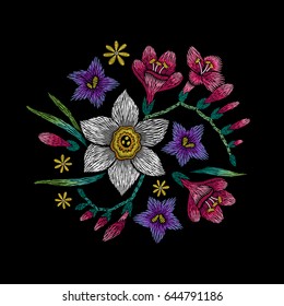 Embroidery circle floral pattern with narcissus, freesia and bellflower on black background. Vector fashion ornament