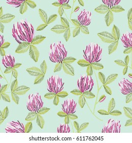 Embroidery colorful ethnic floral design with clover. Vector seamless pattern with flowers ornament on blue background for fashion design.	
