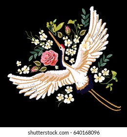 Embroidery colorful floral pattern with flowers, japanese white crane. Vector traditional folk fashion ornament on black background.