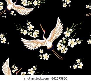 Embroidery colorful floral pattern with flowers, japanese white crane. Vector traditional folk fashion ornament on black background.