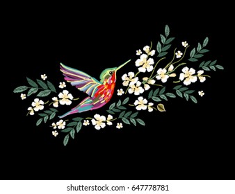 Embroidery colorful floral pattern with japanese flowers, hummingbird. Vector traditional folk fashion ornament on black background.