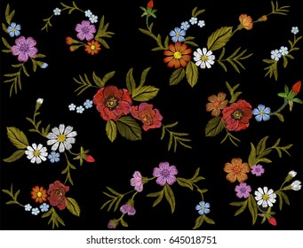 Embroidery colorful floral pattern with red roses and forget me not flowers. Vector traditional folk fashion ornament on black seamless background.