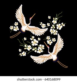 Embroidery colorful floral pattern with sakura flowers, japanese white crane. Vector traditional folk fashion ornament on black background.