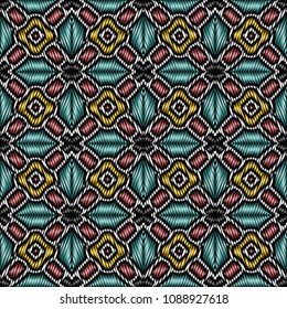 Embroidery colorful pattern with geometric ornament.
