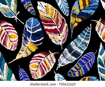 Embroidery colorful seamless pattern  background with feathers. Vector traditional folk fashion ornament on black background.
