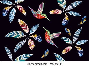 Embroidery colorful seamless pattern background with feathers, hummingbirds. Vector traditional folk fashion ornament on black background.