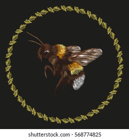 Embroidery colorful trend pattern with bumblebee. Vector folk striped bee with ring of leaves ornament on black background.