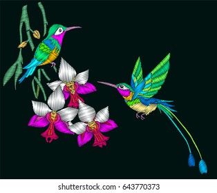 Embroidery with couple of hummingbirds and orchid flowers.