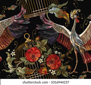 Embroidery crane birds, golden cage and roses seamless pattern. Template for clothes, textiles, t-shirt design. Classical embroidery two Japanese cranes, gold cage and red buds of roses art pattern 