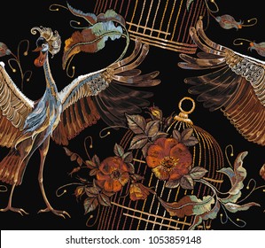 Embroidery crane birds, golden cage and roses seamless pattern. Classical embroidery two Japanese cranes, gold cage and red buds of roses art pattern. Template for clothes, textiles, t-shirt design 