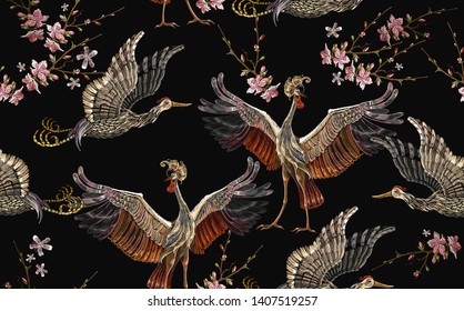 Embroidery crane birds and sakura flowers seamless pattern. Asian template for clothes, textiles, t-shirt design. Japanese art 