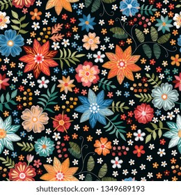 Embroidery ditsy seamless pattern with colorful wild flowers on black background.