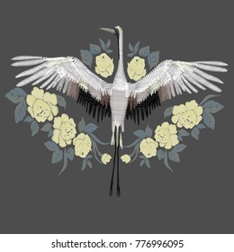 Embroidery. Embroidered design element - bird - crane - in vintage style on a black background, vector illustration.