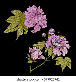 Embroidery. Embroidered design elements with flowers and leaves in vintage style on a black background. Stock vector illustration.