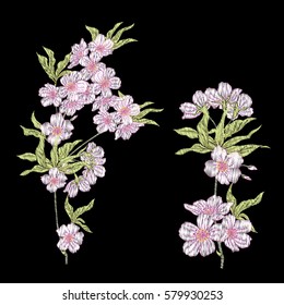 Embroidery. Embroidered design elements with sakura flowers and leaves in vintage style on a black background. Stock vector illustration.