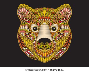 Embroidery ethnic patterned ornate head of brown bear. 