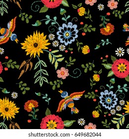 Embroidery ethnic seamless pattern with birds and fantasy flowers. Vector embroidered traditional floral design for fashion fabric.