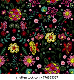 Embroidery ethnic seamless pattern with small wild fantasy flowers. Vector embroidered floral design for fashion wearing