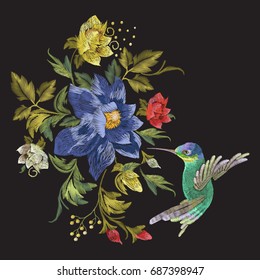 Embroidery fashion pattern with hummingbird and exotic flowers. Vector embroidered floral ornament with bird on black background for clothing design.