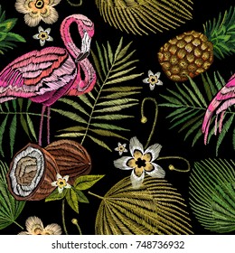 Embroidery flamingo , palm tree leaves, pineapple, coconut tropical seamless pattern. Fashionable template for design of clothes. Embroidery pink flamingos, tropical summer fashion background 