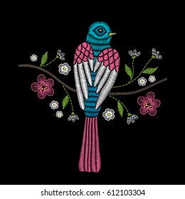 Embroidery floral pattern with tree branch and bird on black background. Vector fashion ornament