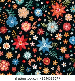 Embroidery flowers in red, yellow and blue colors on black background. Floral seamless pattern.