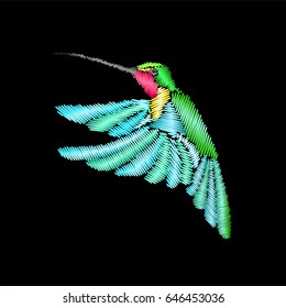 Embroidery flying bird isolated on black background. Template with hummingbird for clothing patch.