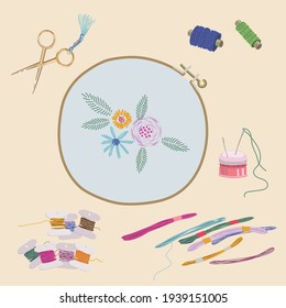 Embroidery is a great activity. A set of embroidery tools. Beautiful floral arrangement. Colorful thread, scissors for needlework, needle holder, embroidery needles, embroidery frames and canvas.