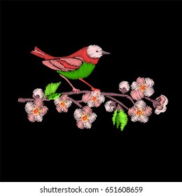 Embroidery Japanese Robin bird and tree branch isolated on black background. Sakura blossom flowers.