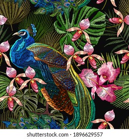 Embroidery peacocks and orchid exotic tropical flowers. seamless pattern. Fashionable template for design of clothes. Fashion tropical birds. Jungle forest art 