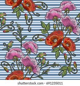 Embroidery poppies and  pink flowers seamless pattern against background in blue strip. Beautiful poppies classic embroidery. Fashionable template for design of clothes, t-shirt design 
