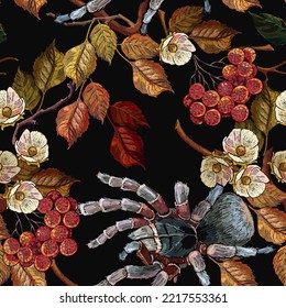 Embroidery red branches of a mountain ash berry, white flowers, autumn leaves and spider. Gothic template for design of clothes. Classical embroidery red berries of mountain ash art pattern