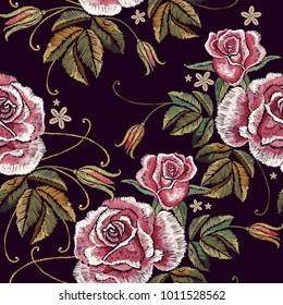 Embroidery roses seamless pattern. Beautiful buds of red roses classical embroidery on black background. Template for clothes, textiles, t-shirt design