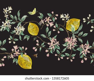 Embroidery seamless floral pattern with branch of flowers and lemon . Vector traditional folk cherry blossom, bees and butterflies on black background for design.