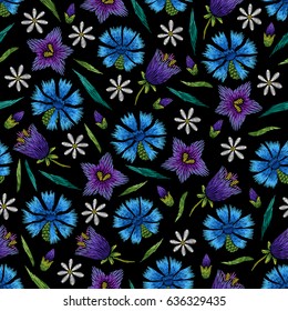 Embroidery seamless floral pattern with cornflower, chamomile, bellflower on black background. Vector fashion ornament