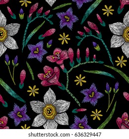 Embroidery seamless floral pattern with narcissus, freesia and bellflower on black background. Vector fashion ornament