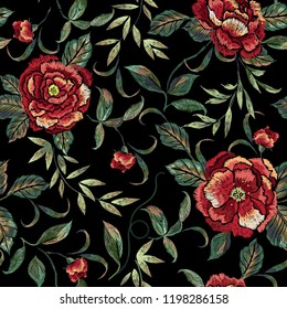 Embroidery seamless floral pattern with red roses. Vector traditional embroidered bouquet with flowers on black background for clothing design.
