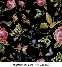 Embroidery seamless floral pattern with roses and butterflies. Vector traditional embroidered bouquet with flowers on black background for clothing design.