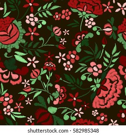 Embroidery seamless pattern with beautiful flowers. Vector floral ornament on black background. Embroidery for fashion textile and fabric.